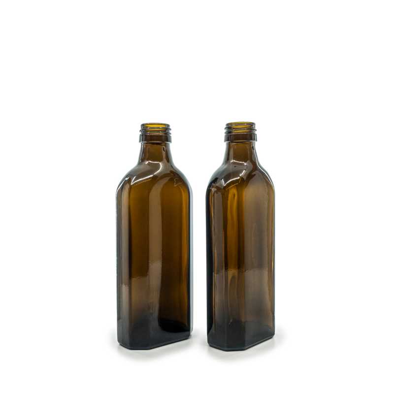 Theglass bottle is made of thick, dark brown glass with avolume of 250 ml. It is used for storing liquids, which thanks to its colour it effectively protects fr