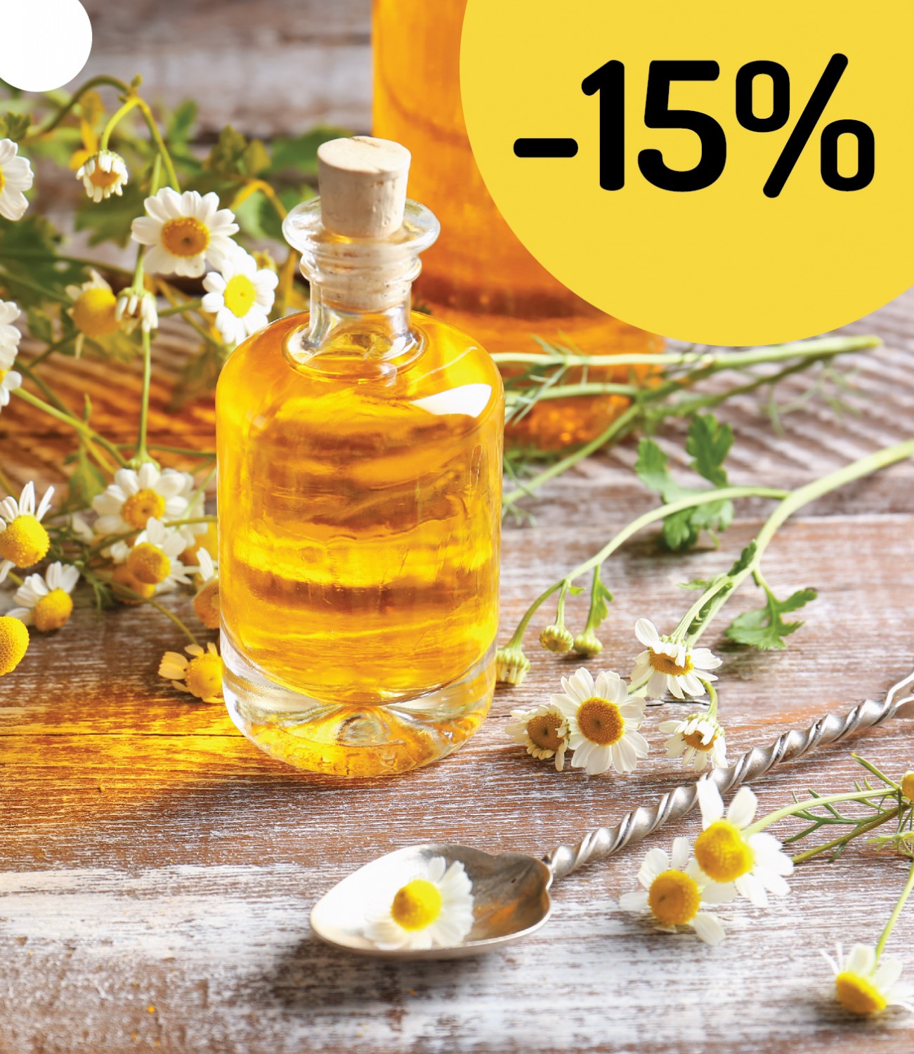 Zľava -15% na všetky suroviny na tvorbu kozmetiky v Handymade s harmančekom a sklenenou fľaštičkou so žltou tekutinou.
